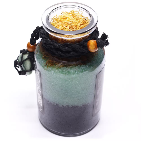 Decorative jar with layered sand and a lid on a white background