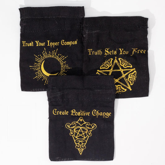 Three black drawstring bags with gold text and symbols on a white background