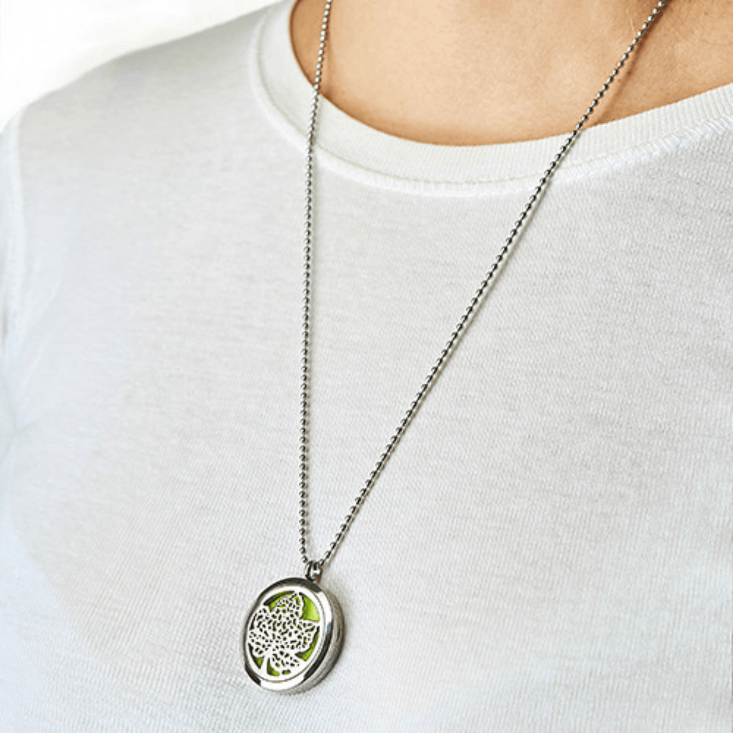 Necklace with a leaf pendant on a white shirt