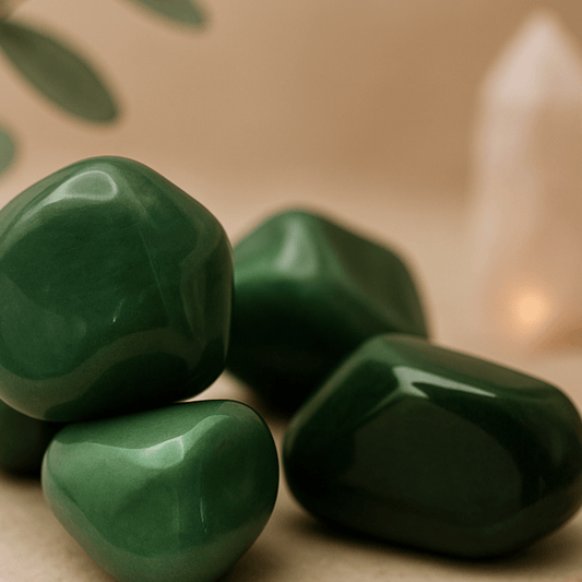 Green Aventurine stones on a beige surface with a soft focus background