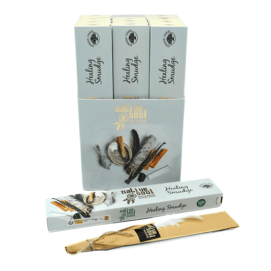 A set of Naliue Soul Healing Smudge boxes and individual packets on a white background. The packaging is a pale blue-gray color with illustrations of herbs, bark, and the individual packets are made of natural brown paper with a black and gold label.