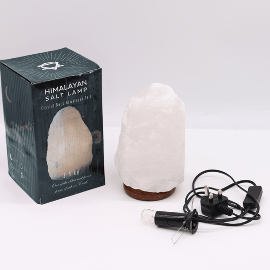 Himalayan salt lamp with packaging and plug on a white background