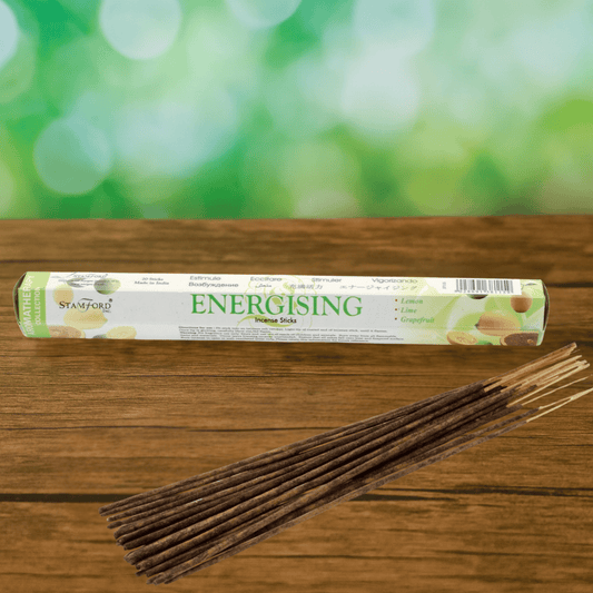 Energising incense sticks with packaging on a wooden surface
