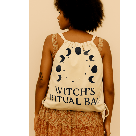 Person wearing a 'Witch's Ritual Bag' with moon phase design on a beige background