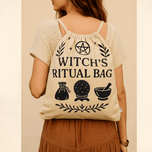 Beige drawstring bag with 'Witch Ritual Bag' text and symbols, being carried by a lady on her back on a beige background.