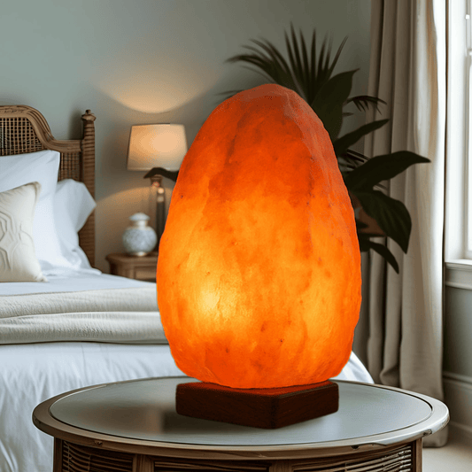 Himalayan salt lamp on a bedside table in a bedroom setting