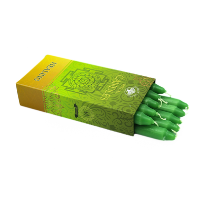 Green candles with decorative box on a white background