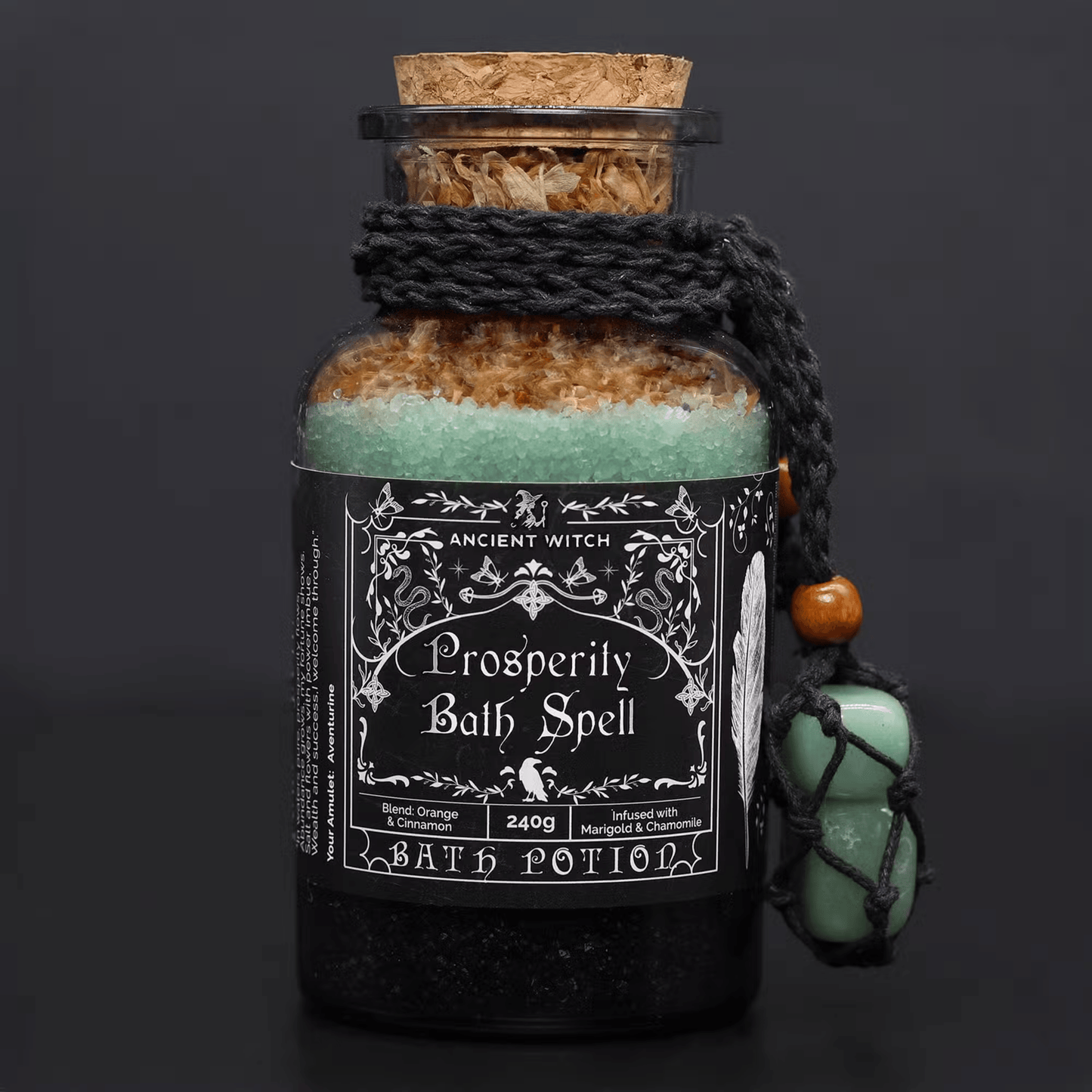 Bottle of 'Prosperity Bath Spell' bath potion with decorative label on a dark background