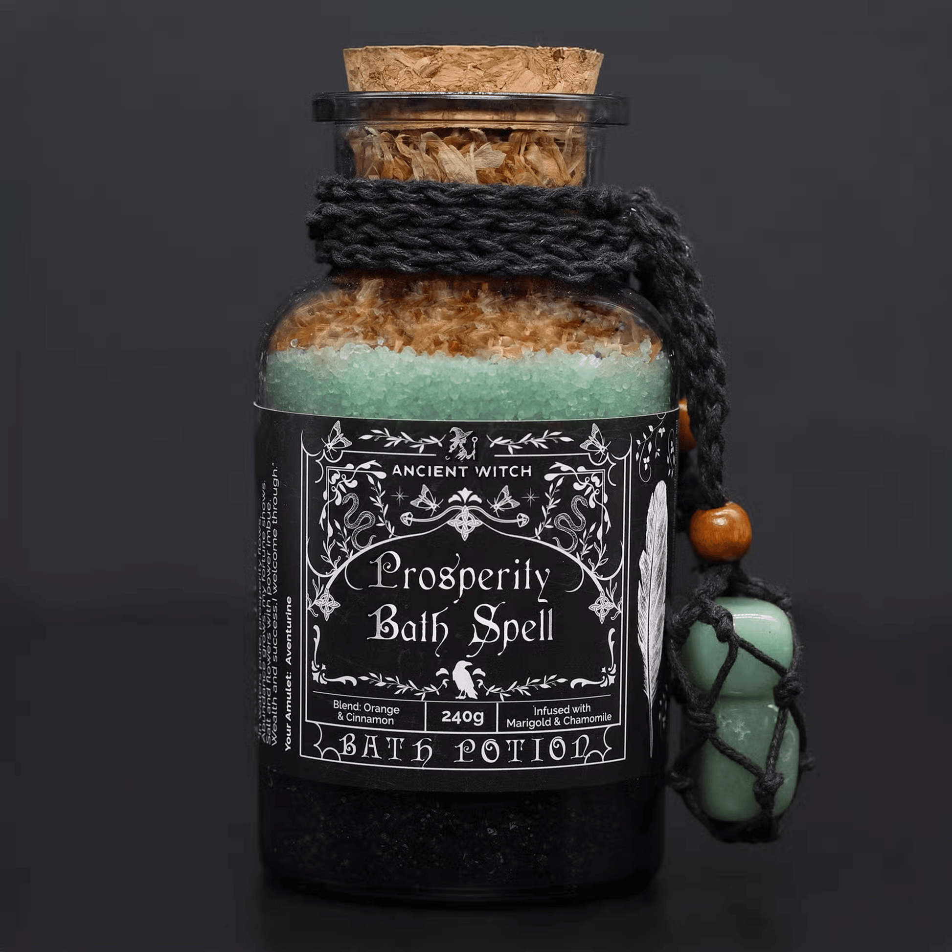 Bottle of 'Prosperity Bath Spell' bath potion with decorative label on a dark background
