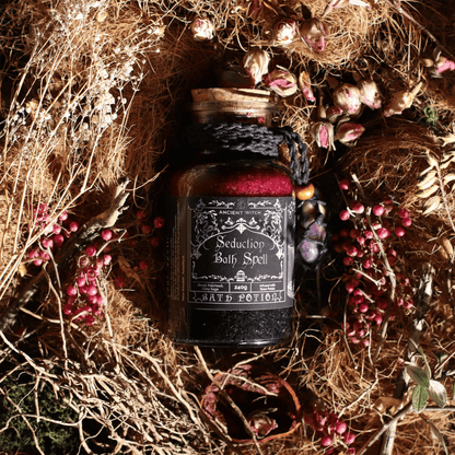 Jar labeled 'Seduction Bath Spell' surrounded by dried plants and berries