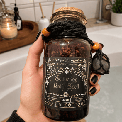 Bottle labeled 'Seduction Bath Spell' held by a hand in a bathroom setting.