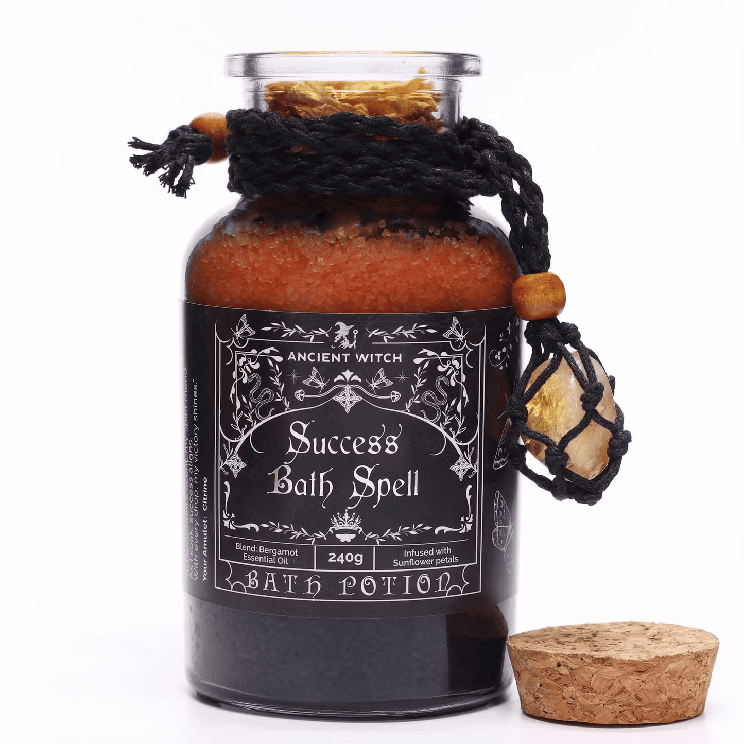 Bottle labeled 'Success Bath Spell' with decorative elements on a white background