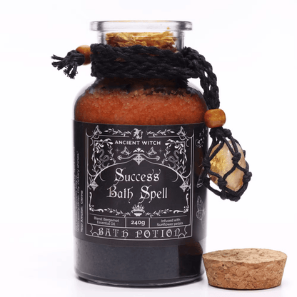 Bottle labeled 'Success Bath Spell' with decorative elements on a white background