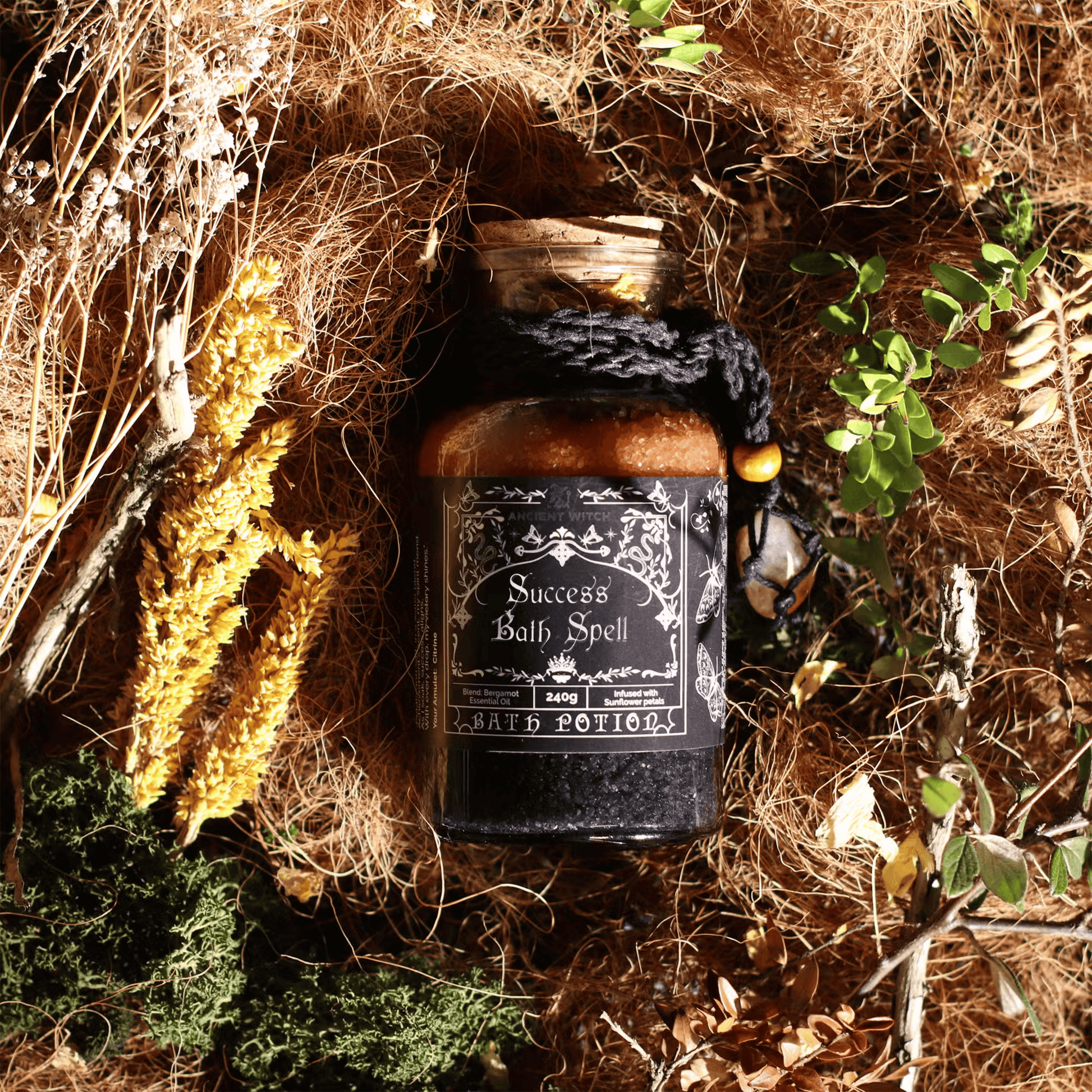 Jar labeled 'Success Bath Spell' surrounded by natural elements on a textured surface