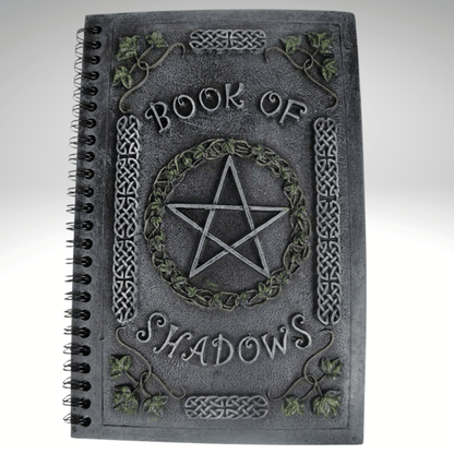 Book of Shadows with pentagram design on a resin cover, on a gray background