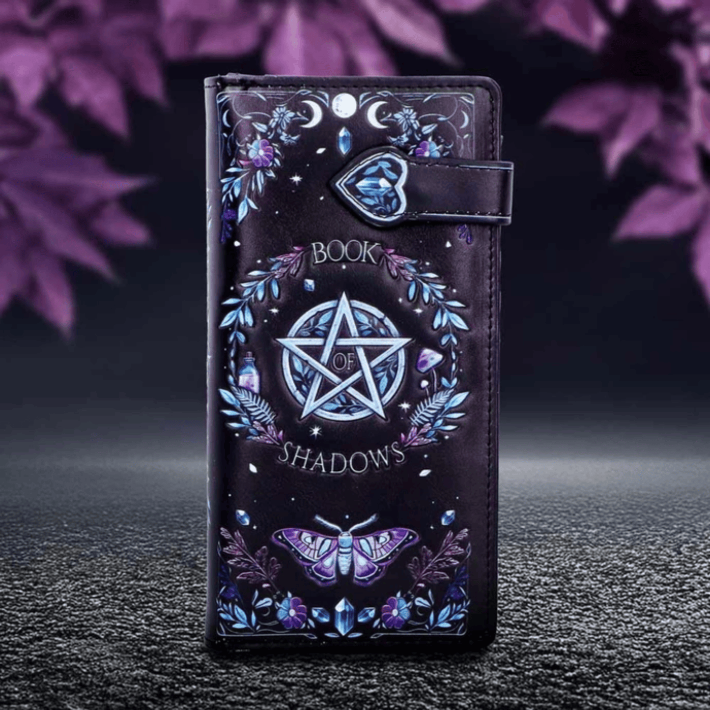 Phone case with pentagram design and 'Book of Shadows' text on a dark background