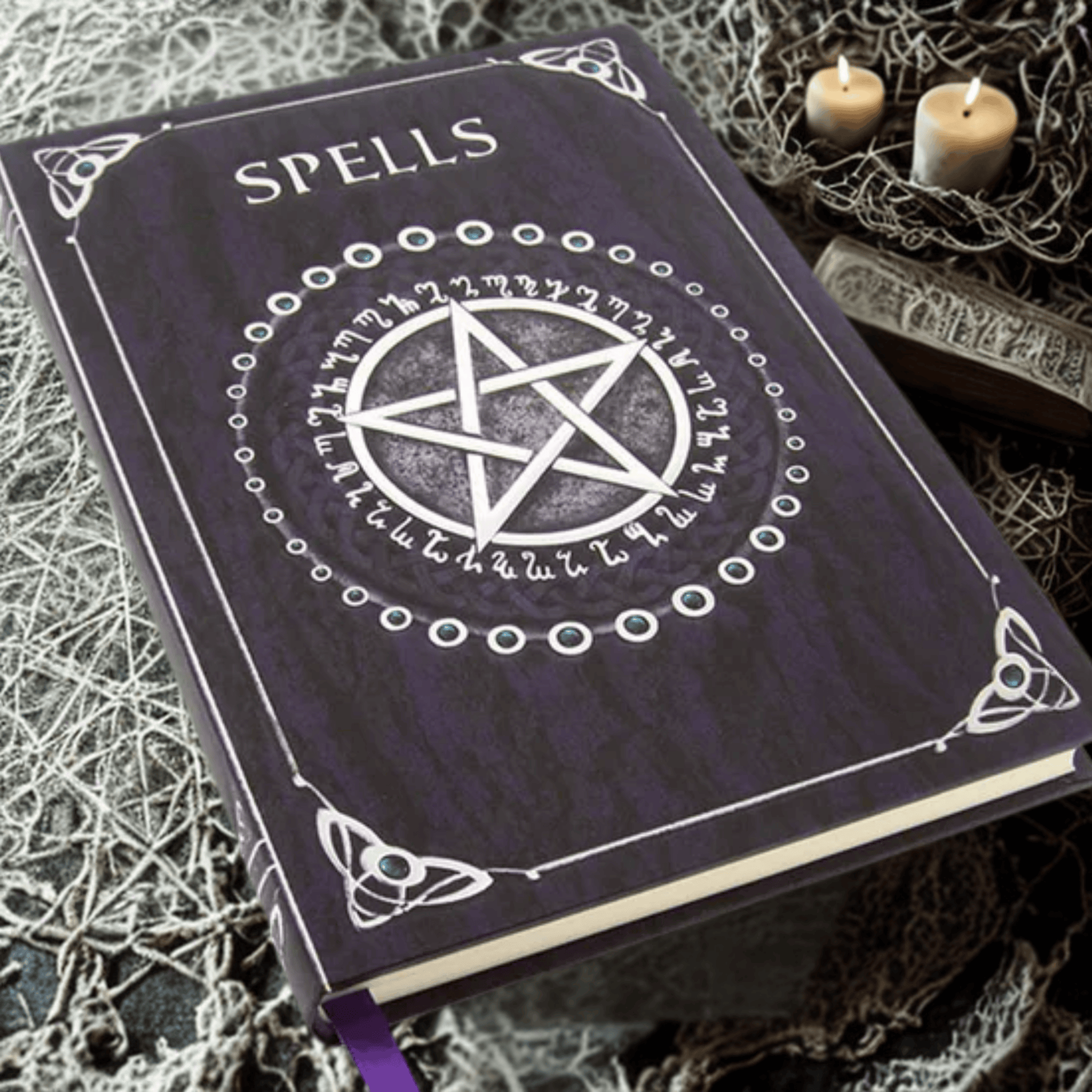 Purple spellbook with a pentagram design on a textured surface with candles.