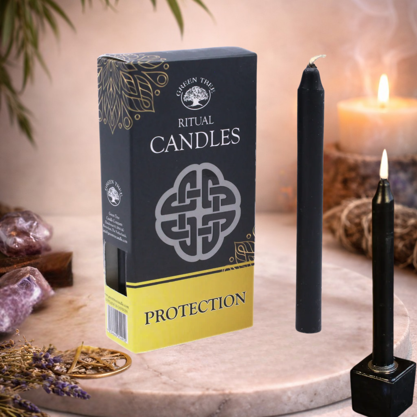 Box of 'Protection' ritual candles with a lit candle and lighter on a marble surface.