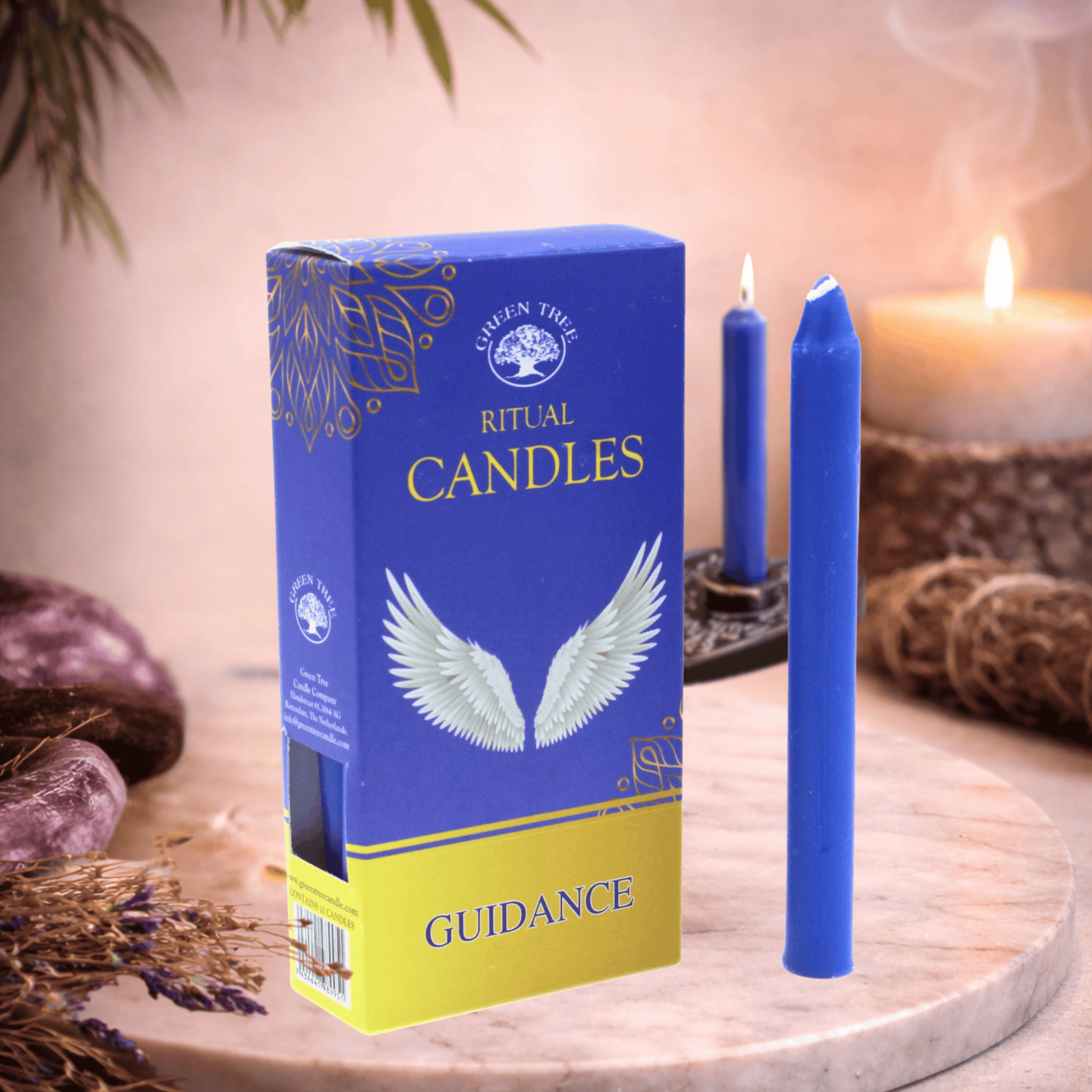 Blue ritual candles with packaging labeled 'Guidance' on a wooden surface.