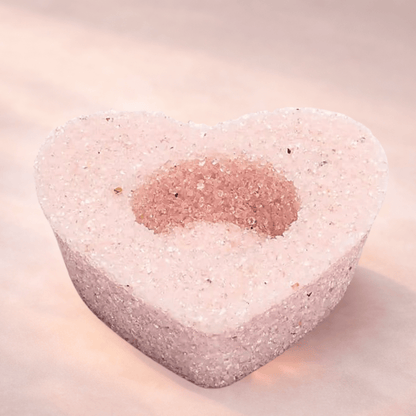 Heart-shaped Rose Quartz candle holder for tealights on a light background