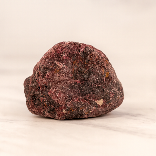Red Garnet rough stone on a light background