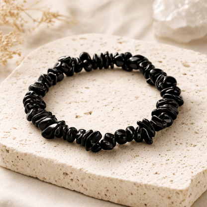 Black Crystal smooth chips bracelet on a cream coloured stone