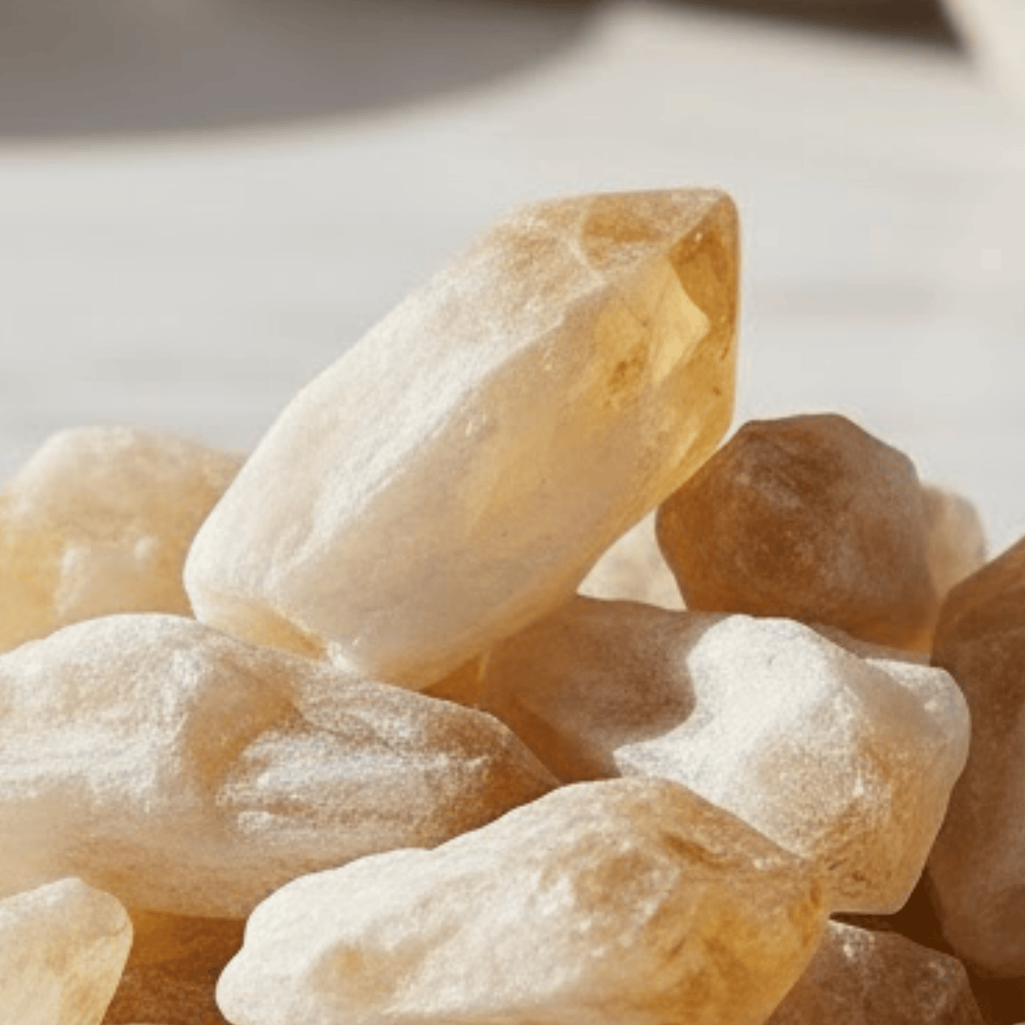 Close-up of amber-colored crystal points on a light background