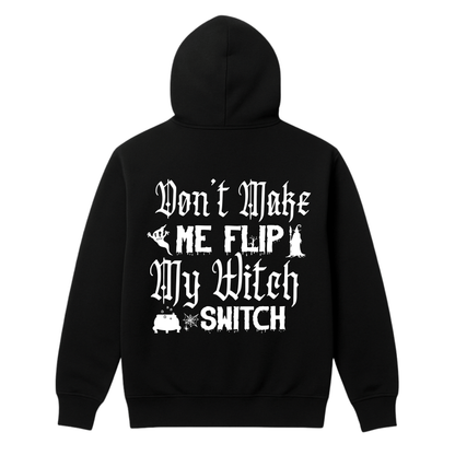 A black hoodie with text Dont make me flip my witch switch and witchy graphics in white on the back of the hoodie on a white background