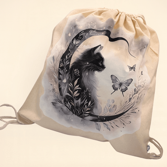 Drawstring bag with a black cat and butterfly Cresent moon design on a beige background 
