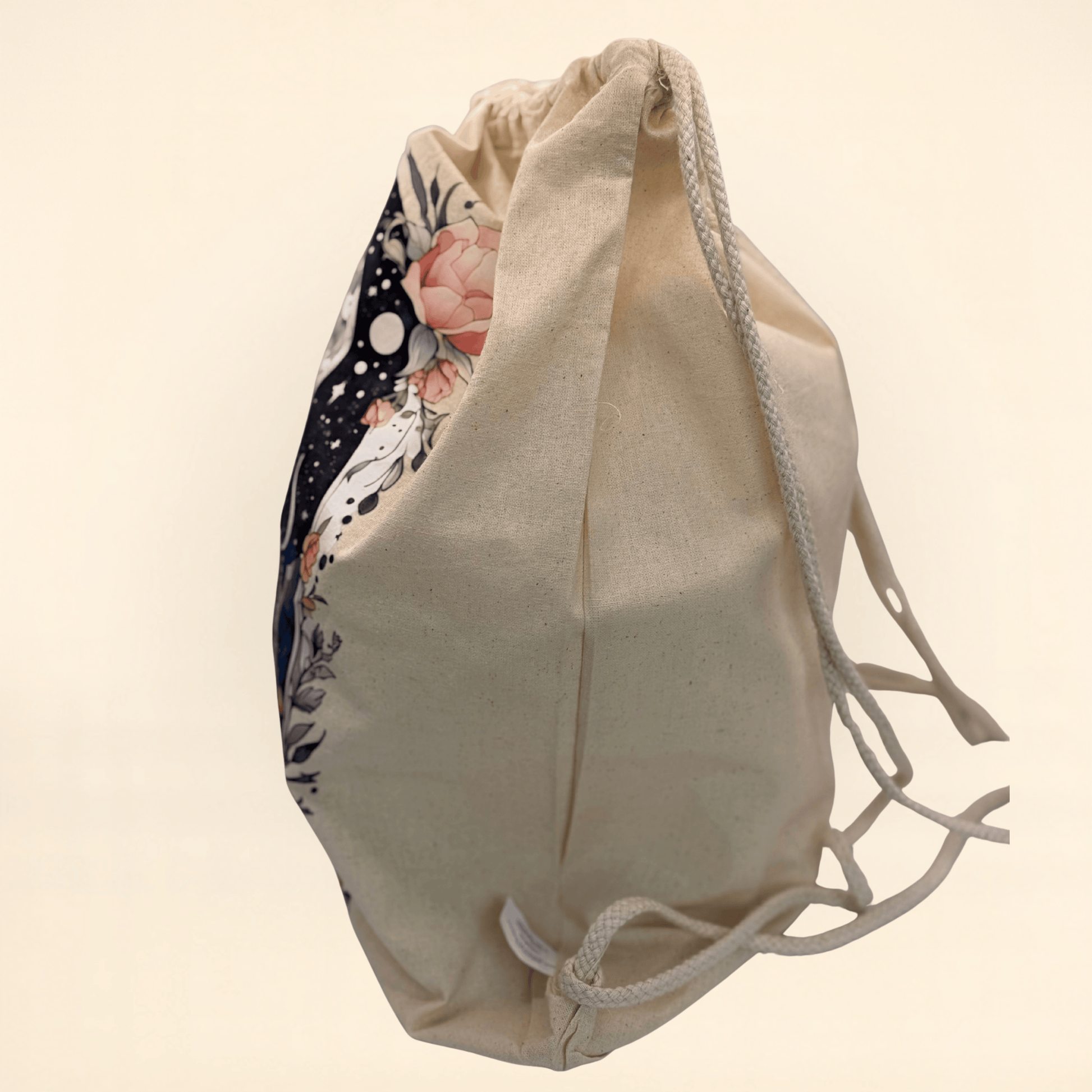 Beige drawstring bag, side view, with floral pattern on a beige background