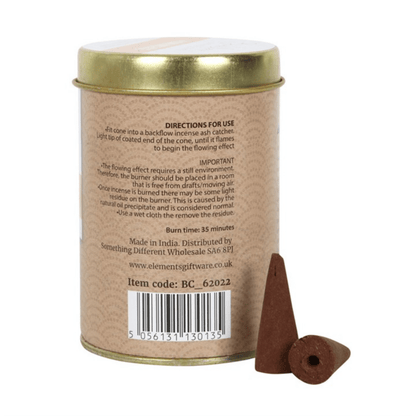 Back of tin with directons and ingriedents. Backflow Incense Cones container with frankincense cones on a light background
