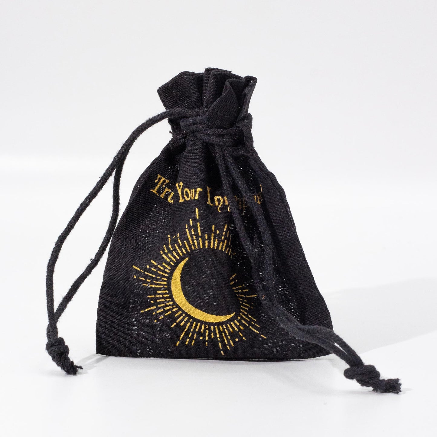 Black drawstring bag with gold crescent moon and text design on a white background