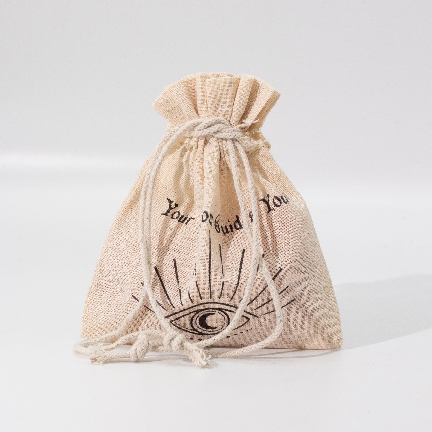 Beige drawstring bag with black text and symbol on a light gray background