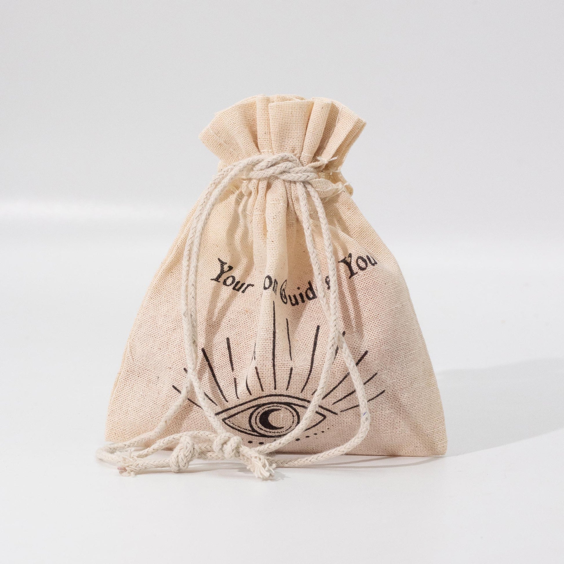 Beige drawstring bag with black text and symbol on a light gray background