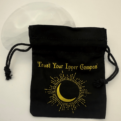 Black drawstring pouch with gold text and crescent moon design on a white background