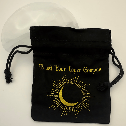 Black drawstring pouch with gold text and crescent moon design on a white background