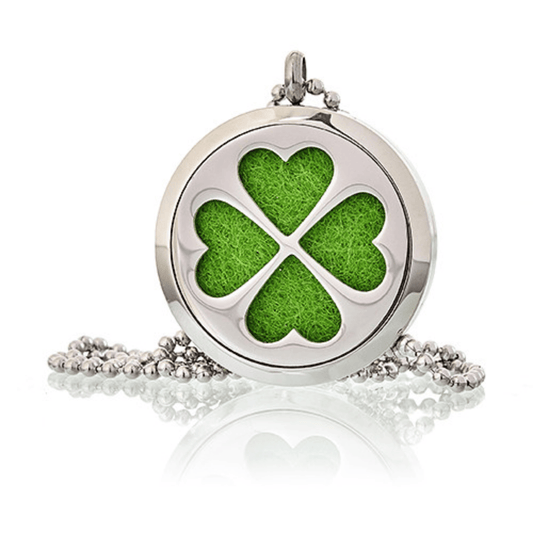 Round locket with green four-leaf clover design on a white background