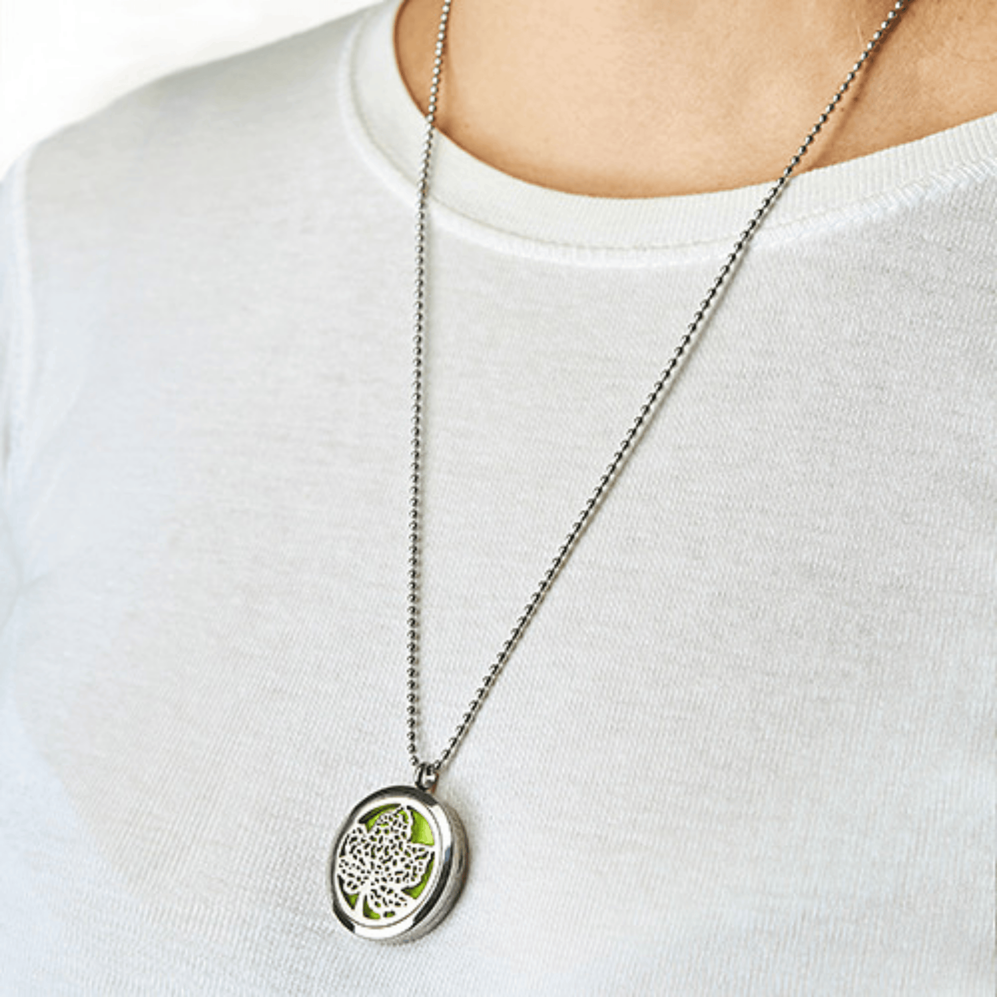 Necklace with a leaf pendant on a white shirt