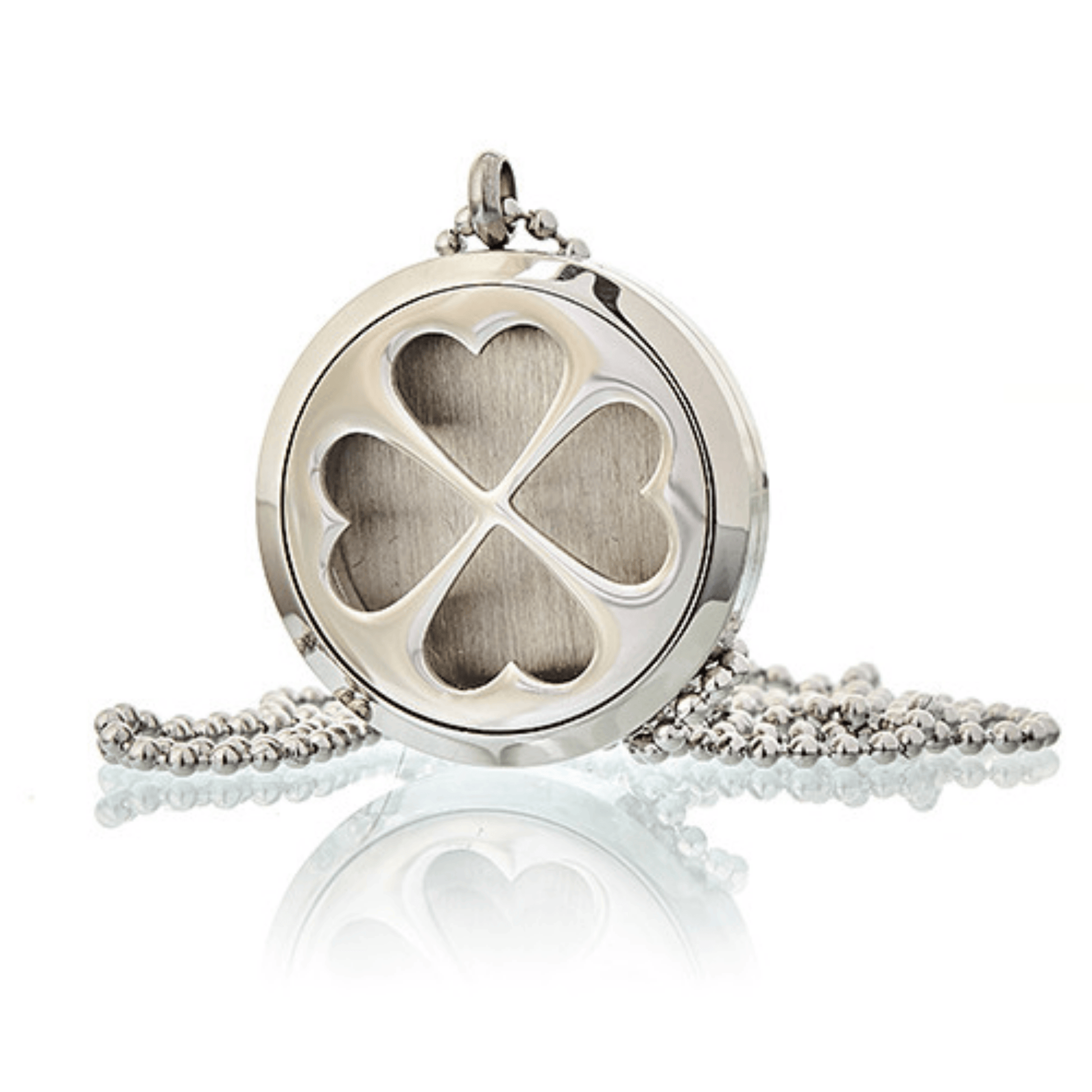 Silver locket with clover design on a white background
