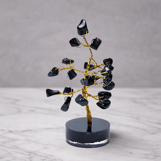 Black agate crystal gemstone tree with dark polished stones on a decorative base, used for grounding, protection and calming feng shui home decor