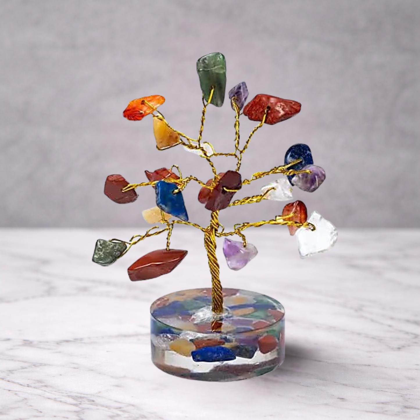 7 chakra crystal gemstone tree with multicolour stones on a decorative base, used for feng shui, energy balance and spiritual home decor