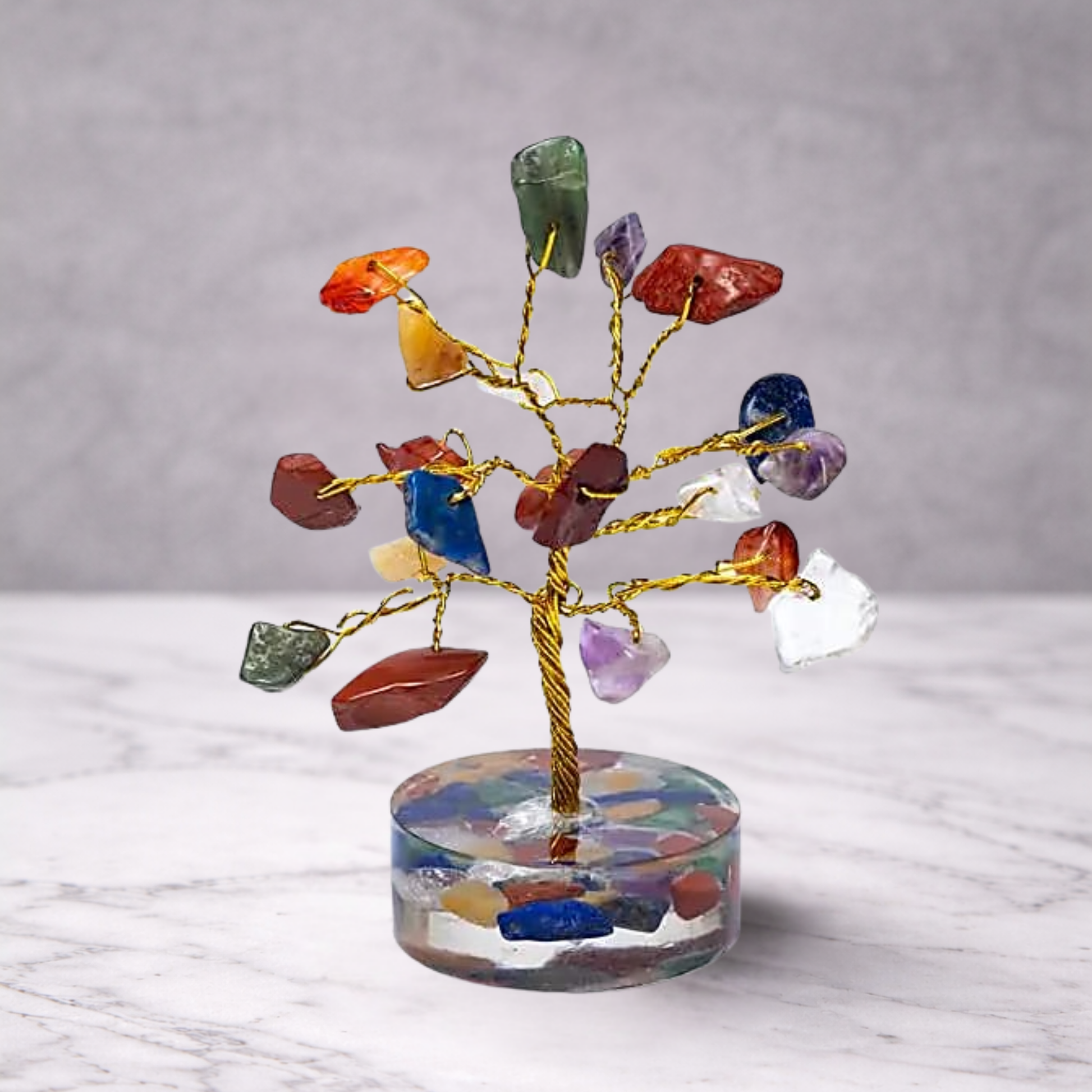 7 chakra crystal gemstone tree with multicolour stones on a decorative base, used for feng shui, energy balance and spiritual home decor