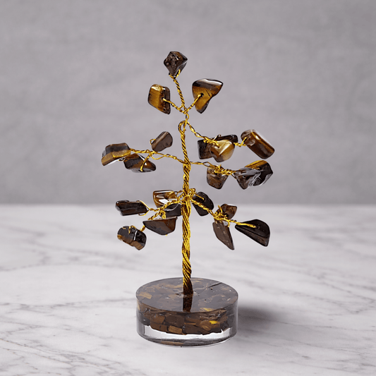 Decorative tree sculpture with brown and gold elements on a marble surface