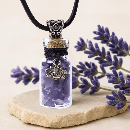 Necklace with a small bottle pendant containing purple stones, set against a background of lavender flowers.