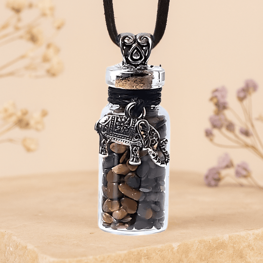 Glass pendant with stones and decorative elements on a beige background
