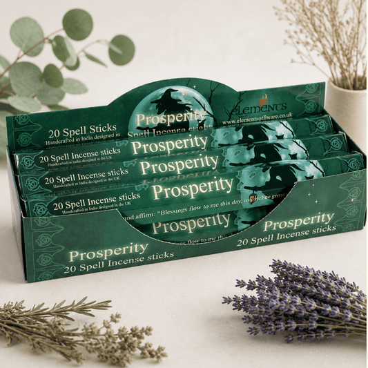 Display of 'Prosperity' spell incense sticks packaging with lavender and herbs on a light background