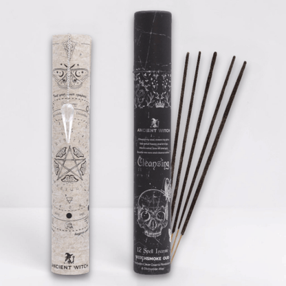 Incense sticks with packaging featuring mystical designs on a white background and a white pointed crystal attached to a silver chain draped over a paper map.