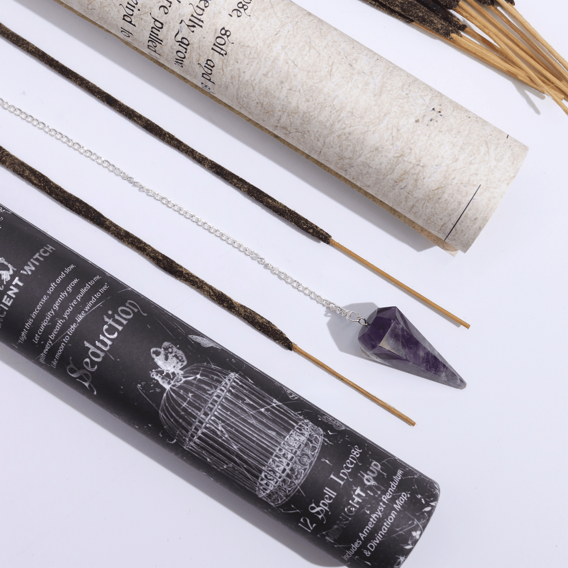 Incense sticks with packaging and a crystal on a white background