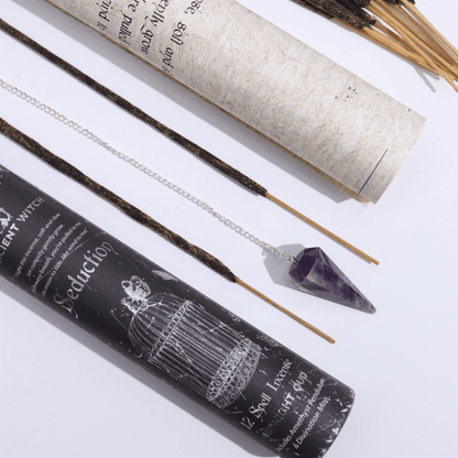 Incense sticks with packaging and a crystal on a white background