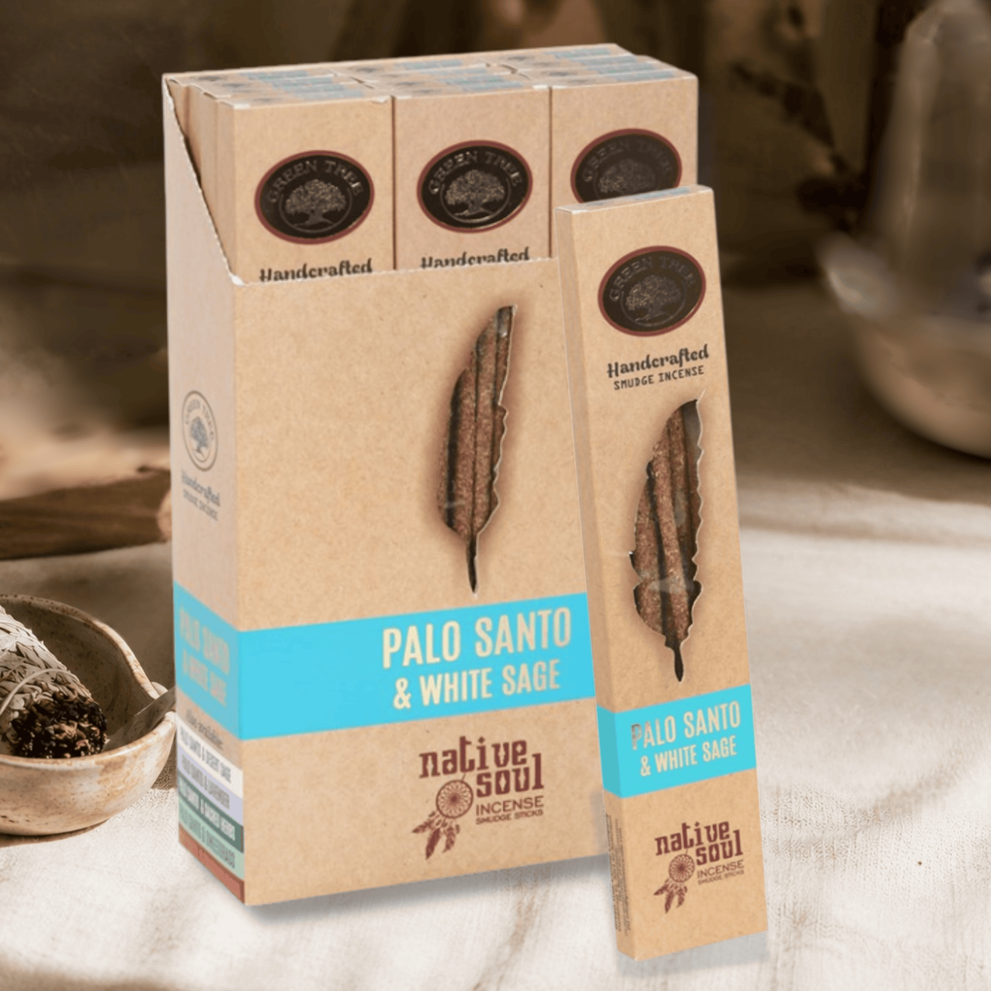 Native Soul Palo Santo & White Sage incense sticks in a kraft paper box with a matching single stick standing in front, photographed on a softly lit tabletop with a bowl and blurred background.